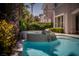 The backyard features a rock waterfall, providing a relaxing ambiance for swimming at 504 Pinnacle Heights Ln, Las Vegas, NV 89144