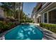 Luxurious backyard pool surrounded by mature trees and manicured hedges on a sunny day at 504 Pinnacle Heights Ln, Las Vegas, NV 89144