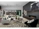 Contemporary living room with fireplace, stylish décor, and sliding glass doors to an outdoor seating area with mountain views at 5725 N Conquistador St, Las Vegas, NV 89149