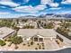 Aerial view of a well-manicured home showcasing desert landscaping, a three-car garage, and mountain views at 6206 Rio Camuy Ave, Las Vegas, NV 89131