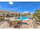 Outdoor patio area with seating and a pool, perfect for entertaining guests and enjoying the backyard at 6206 Rio Camuy Ave, Las Vegas, NV 89131