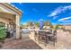 A well-designed backyard with an outdoor kitchen, grill, and ample seating, perfect for gatherings at 6206 Rio Camuy Ave, Las Vegas, NV 89131
