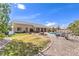 Expansive backyard with manicured lawn, desert landscaping, covered patio, pool, and spa perfect for outdoor living at 6206 Rio Camuy Ave, Las Vegas, NV 89131