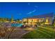 Backyard view of the pool area and patio at twilight at 6206 Rio Camuy Ave, Las Vegas, NV 89131