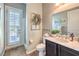 Bathroom featuring a vanity with a marble countertop, a toilet and shower behind shuttered door at 6206 Rio Camuy Ave, Las Vegas, NV 89131