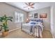 Cozy bedroom featuring a metal frame bed, window with shutters, and plant in a woven basket at 6206 Rio Camuy Ave, Las Vegas, NV 89131