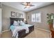 Bedroom with a bed, shuttered window, ceiling fan, and neutral carpet at 6206 Rio Camuy Ave, Las Vegas, NV 89131