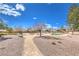 Community park with walking path, seating areas, mature trees, and an area of artificial turf at 6206 Rio Camuy Ave, Las Vegas, NV 89131