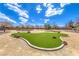 Community park with an area of artificial turf surrounded by a walking path and desert landscaping at 6206 Rio Camuy Ave, Las Vegas, NV 89131