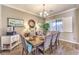 Elegant dining room features a wood table, upholstered chairs, and modern chandelier at 6206 Rio Camuy Ave, Las Vegas, NV 89131