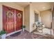 Cozy covered front porch with double doors, decorated with wreaths, and comfortable seating area at 6206 Rio Camuy Ave, Las Vegas, NV 89131