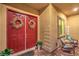 Welcoming covered front porch with a double-door entrance, wreath decorations, and comfortable seating area at 6206 Rio Camuy Ave, Las Vegas, NV 89131