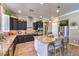 Contemporary kitchen with dark cabinets, granite counters, stainless steel appliances, and island with seating at 6206 Rio Camuy Ave, Las Vegas, NV 89131