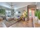 Inviting living room featuring a large sectional sofa, stylish decor, and wood-look floors at 6206 Rio Camuy Ave, Las Vegas, NV 89131