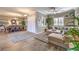 Open-concept living and dining area featuring neutral tones, wood-look flooring, and plenty of natural light at 6206 Rio Camuy Ave, Las Vegas, NV 89131