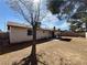 Spacious backyard featuring a covered patio and mature trees, perfect for outdoor living and entertaining at 6412 Churchfield Blvd, Las Vegas, NV 89103