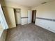 This bedroom has neutral walls, a standard closet, carpet, and a window at 6412 Churchfield Blvd, Las Vegas, NV 89103