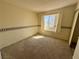 This bedroom has neutral walls, a standard closet, and a window at 6412 Churchfield Blvd, Las Vegas, NV 89103