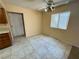 This dining area has tile floors, neutral paint, and a ceiling fan at 6412 Churchfield Blvd, Las Vegas, NV 89103