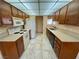 Functional kitchen with tile flooring, appliances, and ample cabinet space at 6412 Churchfield Blvd, Las Vegas, NV 89103