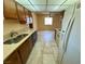This kitchen has a dual stainless sink, wood cabinets, and white appliances at 6412 Churchfield Blvd, Las Vegas, NV 89103