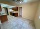 This spacious eat-in kitchen has tile floors, wood cabinets, and standard appliances at 6412 Churchfield Blvd, Las Vegas, NV 89103