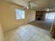 This living room features tile and carpet floors, a fireplace, and ceiling fans at 6412 Churchfield Blvd, Las Vegas, NV 89103