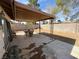 Covered patio with decorative iron supports and an outdoor table at 6412 Churchfield Blvd, Las Vegas, NV 89103