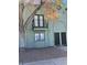 Two-story townhome showcasing dual entry doors and a quaint balcony, all set against a backdrop of low-maintenance landscaping at 7095 Burcot Ave # F83, Las Vegas, NV 89156