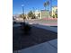 Exterior street view showcasing building's architectural details, desert landscaping, and proximity to community amenities at 7095 Burcot Ave # F83, Las Vegas, NV 89156