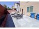 Wide backyard with seating area, table, and ample space for outdoor activities at 7403 Benlomond Ave, Las Vegas, NV 89179