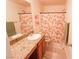 Bright bathroom with granite countertops and stylish peach-themed shower curtain at 7403 Benlomond Ave, Las Vegas, NV 89179