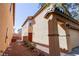Inviting home exterior featuring a cozy walkway leading to the front door, well-maintained landscaping and a two-car garage at 7403 Benlomond Ave, Las Vegas, NV 89179