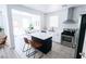 Bright kitchen featuring stainless steel appliances, lots of natural light and seamless transition into the dining area at 7403 Benlomond Ave, Las Vegas, NV 89179