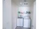 Functional laundry room with a washer, dryer, and shelving for storage at 7403 Benlomond Ave, Las Vegas, NV 89179