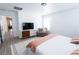 Bright primary bedroom featuring a cozy chair, soft decor, and a view to the hallway at 7403 Benlomond Ave, Las Vegas, NV 89179