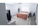 A bright primary bedroom featuring a cozy bed, soft decor, and a view to the windows at 7403 Benlomond Ave, Las Vegas, NV 89179