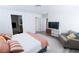 This bedroom features a neutral color palette, a plush bed, and plenty of natural light at 7403 Benlomond Ave, Las Vegas, NV 89179