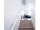 Staircase with carpeted steps leading to a bright living space with natural light and a cozy sofa at 7403 Benlomond Ave, Las Vegas, NV 89179