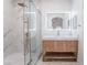 Modern bathroom featuring marble tile, glass shower, and lighted mirror above vanity at 9000 Las Vegas Blvd # 1043, Las Vegas, NV 89123