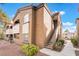 Apartment building featuring a multi-level design, a neutral color scheme, and a landscaped yard at 9000 Las Vegas Blvd # 1043, Las Vegas, NV 89123