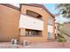 Multi-story building with balconies, stucco exterior, and landscaped surroundings at 9000 Las Vegas Blvd # 1043, Las Vegas, NV 89123