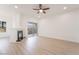 A living room with a fireplace, ceiling fan, a sliding glass door to a balcony, and wood look flooring at 9000 Las Vegas Blvd # 1043, Las Vegas, NV 89123