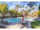 A relaxing pool area with lounge chairs and tables, surrounded by palm trees and greenery at 9000 Las Vegas Blvd # 1043, Las Vegas, NV 89123