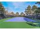 A well-maintained tennis court with a blue surface and a surrounding green space, perfect for recreational play at 9000 Las Vegas Blvd # 1043, Las Vegas, NV 89123