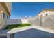 Backyard featuring synthetic grass and a concrete patio area at 9314 Indian Corn Ct # 102, Las Vegas, NV 89178