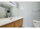 Bathroom featuring a mirror, toilet, sink, and shower with a shower curtain at 9314 Indian Corn Ct # 102, Las Vegas, NV 89178