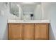 Bathroom featuring wooden cabinets and a mirror at 9314 Indian Corn Ct # 102, Las Vegas, NV 89178
