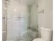 Tiled shower with glass doors and built in bench and cubby for storage at 9314 Indian Corn Ct # 102, Las Vegas, NV 89178
