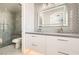 Bathroom with gray tiled walls and a glass shower, featuring and sinks at 9314 Indian Corn Ct # 102, Las Vegas, NV 89178